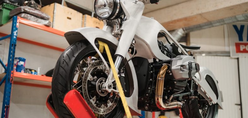 Fixing Custom motorcycle standing in repair shop. Instruments and equipment. Hobbies and unique Jobs